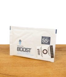 Integra Boost 2-Way Humidity Regulator mit 55% relativer Luftfeuchtigkeit, auf einem Holztisch liegend, vollständige Verpackung sichtbar.