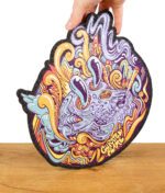 Dab-Mat mit psychedelischem Totenkopf-Design und „Curated Flame“-Schriftzug, auf Holzuntergrund.