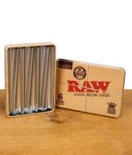 RAW Classic Cone Holder mit geöffnetem Deckel – Aluminiumfächer für sechs King Size Cones, präsentiert auf einem Holztisch.