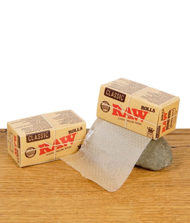 RAW Classic Rolls Kingsize Slim – ungebleichte Endlos-Rollpapierrolle mit Verpackung auf Holztisch.