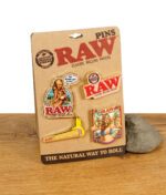 RAW Pins Set mit vier Ansteckern auf Original-Karton – Classic Rolling Papers Design