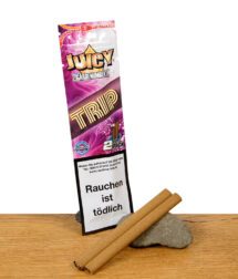 Juicy Zigarrenblätter Trip – zwei aromatisierte Blunt Wraps vor bunter Verpackung im psychedelischen Design