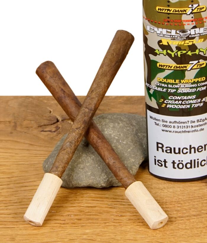 Zwei Cyclones XtraSlo Hyphy Blunts mit Holzfilter kreuzweise vor Dose und Stein arrangiert