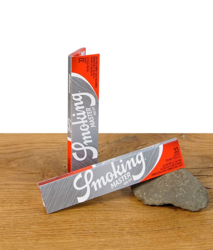 Zwei einzelne Heftchen Smoking Master King Size Slim vor einem Stein platziert