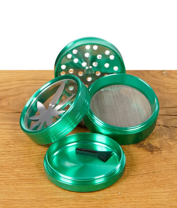 Grüner Grinder in Einzelteilen mit Sieb, Bodenfach und beiliegendem Schaber