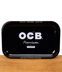 Schwarzes OCB Premium Rolling Tray aus Metall mit weißem Logo und Schriftzug „Made in France“, frontal auf einem Holztisch fotografiert.