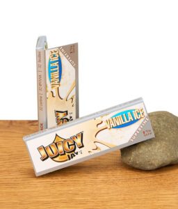 Zwei geschlossene Packungen Juicy Jay's Vanilla Ice Papers im 1 1/4 Format auf Holzuntergrund