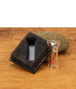 EHLE e.tip Glasfilter für actiTube Slim Filter mit rotem Logo-Aufdruck neben einem schwarzen Schaumstoff-Case und einem Dekostein.