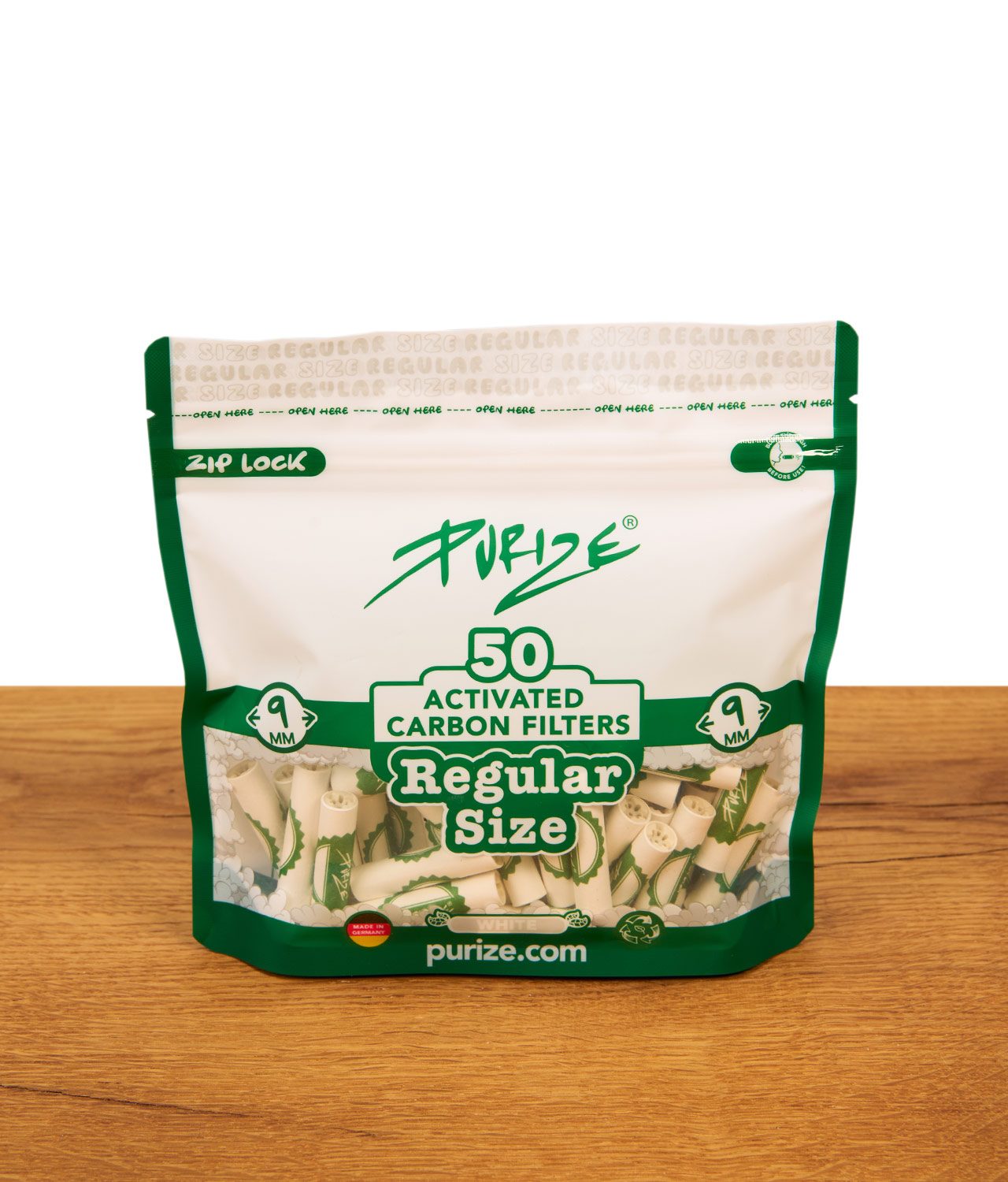 purize-regular-size-filter-weiss-jpg PURIZE Regular Size Filter Weiß im 50er Zip-Beutel. Sichtfenster zeigt weiße 9mm Aktivkohlefilter mit Keramikkappen auf Holztisch.