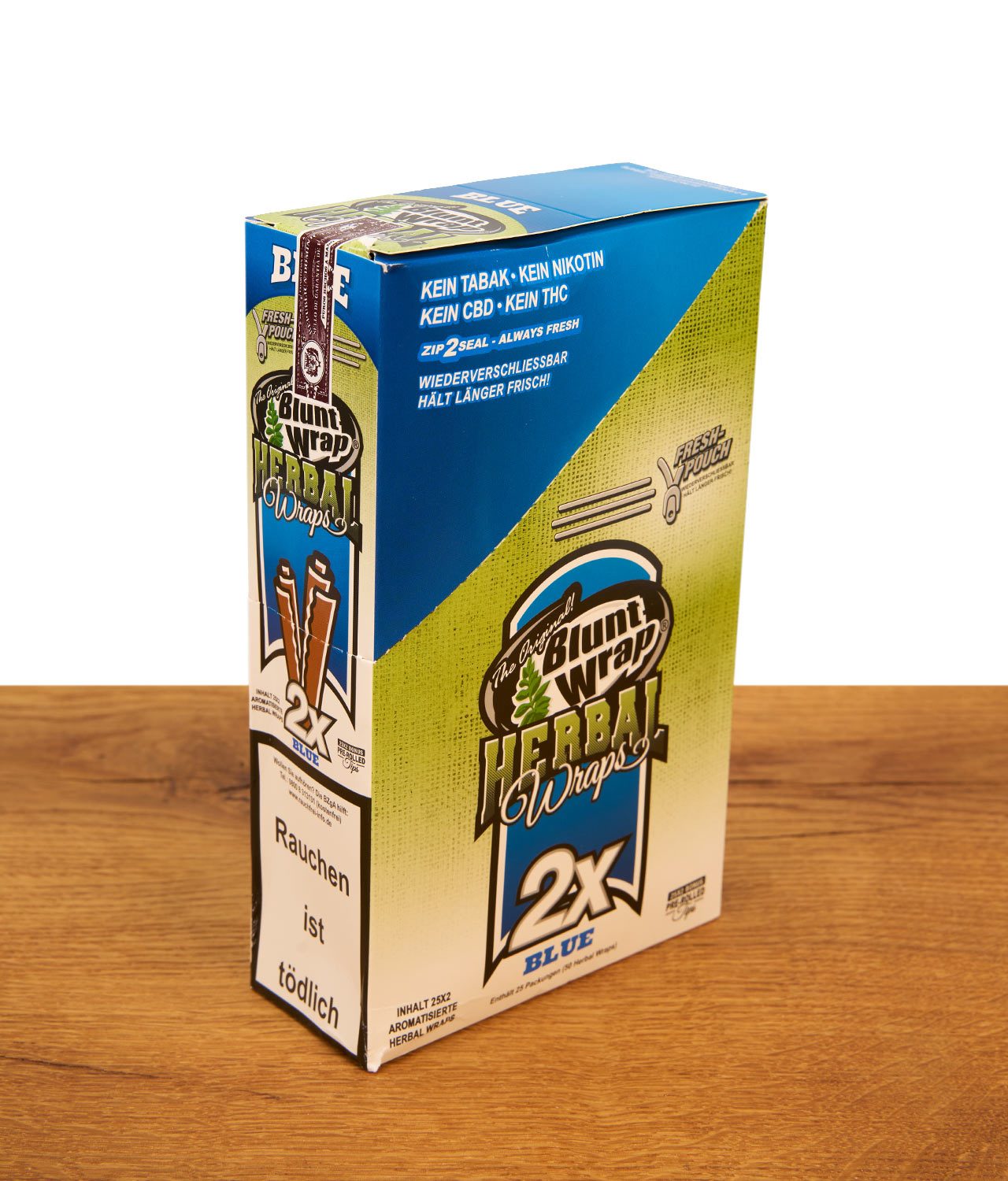 blunt-wrap-herbal-wraps-25er-pack-blue-jpg Blaue Display-Box Blunt Wrap Herbal Wraps 25er Pack Blue auf Holztisch. Tabakfreie Wraps mit Zip-Seal.