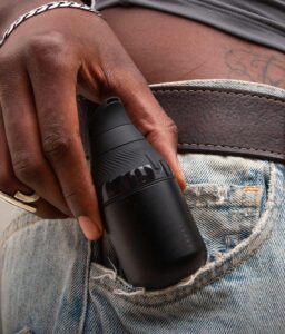 Hand hält Onyx Version des Puffco Proxy Core Vaporizer vor Jeanshose.