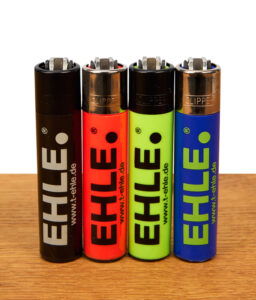 EHLE Clipper Feuerzeuge im 4er Set in Schwarz und Neonfarben mit EHLE-Logo und Web-URL auf einer Holzunterlage.