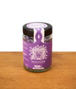 Medusafilters Violet Edition im 100er Glas. Verschlossenes Glas mit 6mm Premium Aktivkohlefiltern auf einem Holztisch.