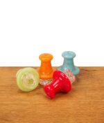 Kollektion der Black Leaf Carb Cap Spinner; eine liegende Kappe zeigt die spiralförmige Unterseite für den gewünschten Wirbel-Effekt im Banger.