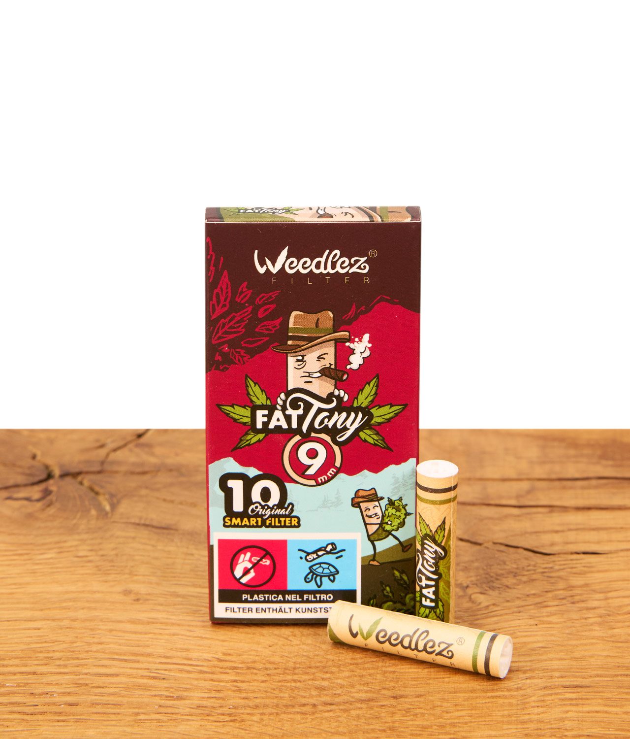 fat-tony-x-weedlez-9mm-filter-10er-pack-jpg Weedlez 'Fat Tony' 9mm Aktivkohlefilter 10er Pack – Faltschachtel mit zwei Einzelfiltern auf Holzuntergrund