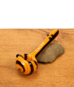 Orange-schwarz gewirbelte Calvo Unique Spoon Pipe Glaspfeife auf einem Stein platziert.