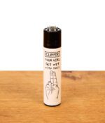 Weißes Clipper-Feuerzeug Adult #1 auf Holz mit Spruch "Your Girl Get Wet With These" und Hand-Grafik.