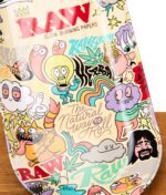 Nahaufnahme vom RAW x Chris Psiacik Skate Deck Rolling Tray mit Markenlogo und "The Natural Way to Roll"-Schriftzug.