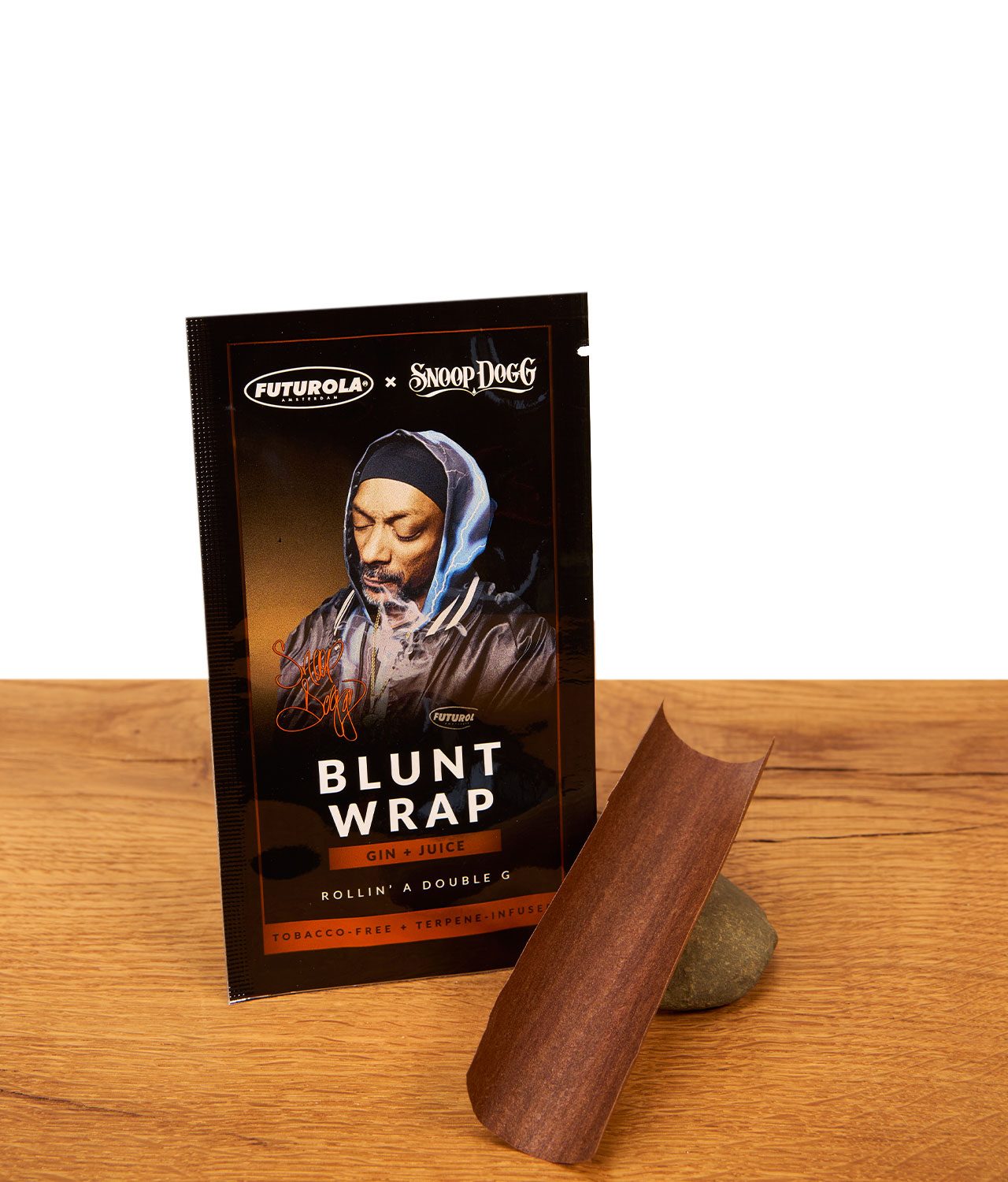 futurola-snoop-dog-blunt-wrap-1-jpg Futurola x Snoop Dogg Blunt Wrap Verpackung Gin & Juice neben ausgepacktem, tabakfreien Wrap.